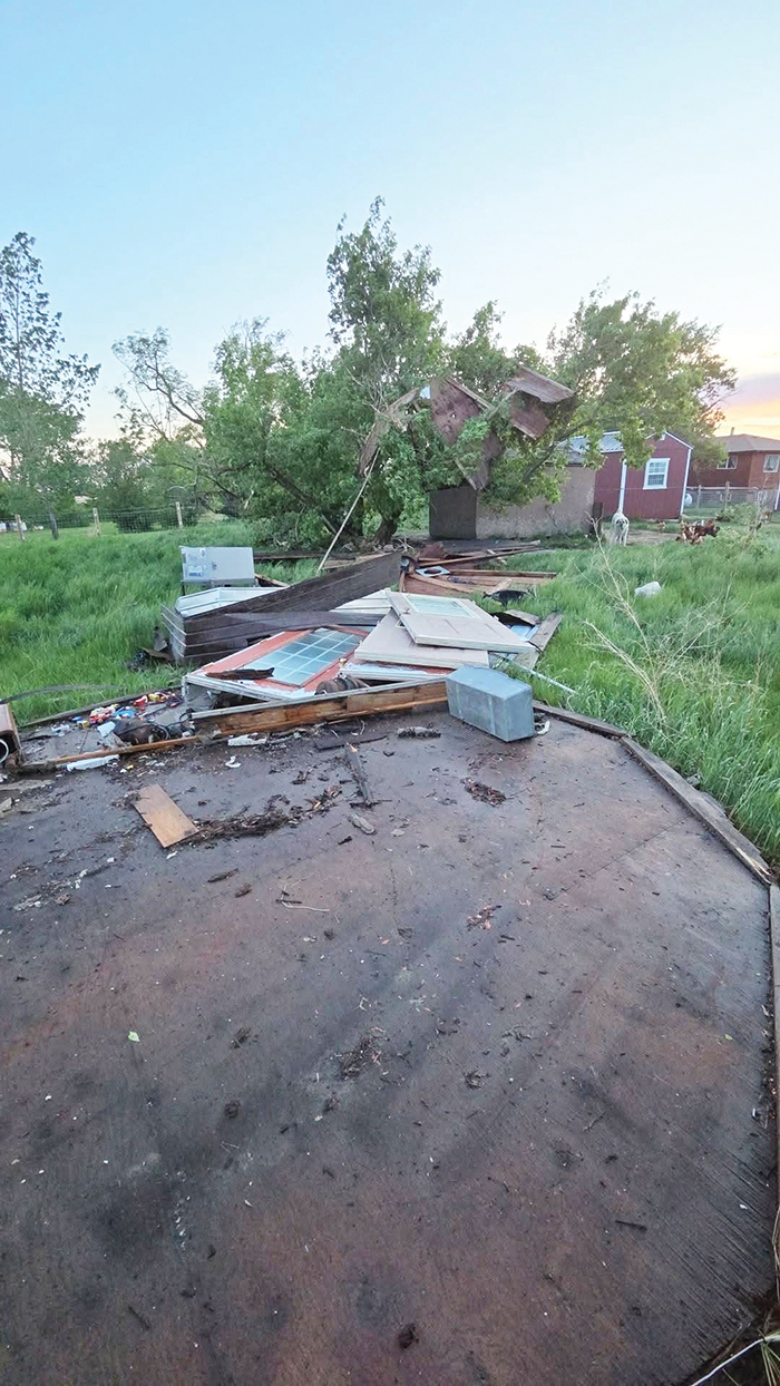 This old grain bin was used for storage on Crystal Harper�s farm. It ended up in a tree. The farm had considerable damage from the June 7 storm. <br />
<p class=